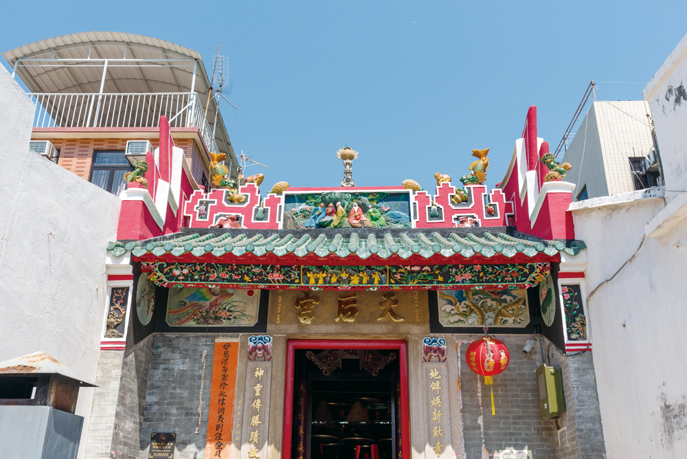 坪洲天后宮夾在兩座建築物之間，屋脊裝飾漂亮。